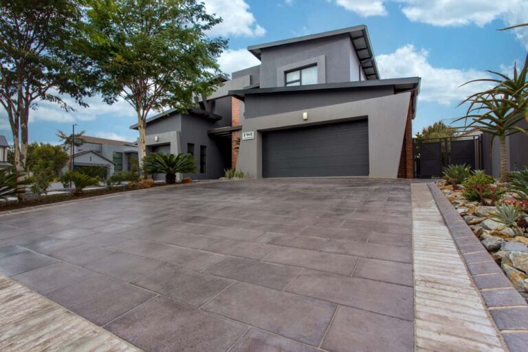 Home different size pavers used at a modern driveway in shades of grey 768x512